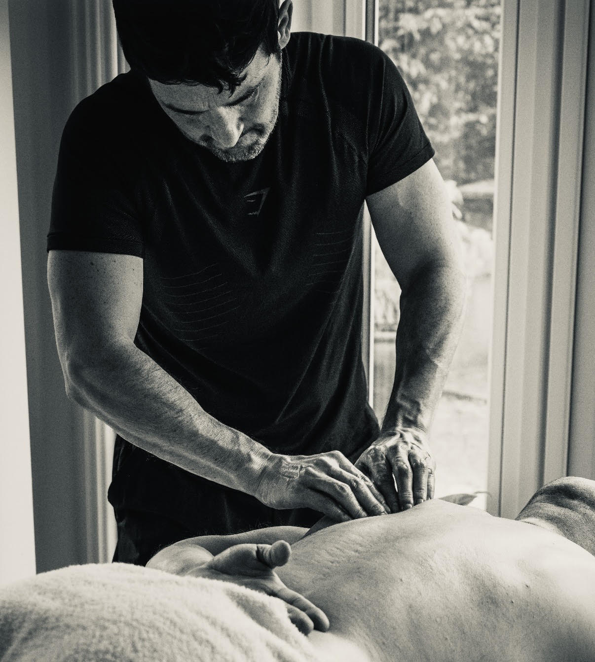 Close up of sports massage therapy on runner's legs.